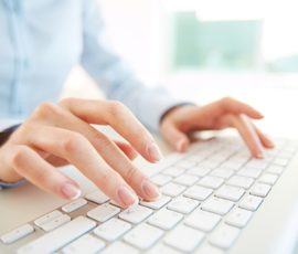 Hands of an office woman typing